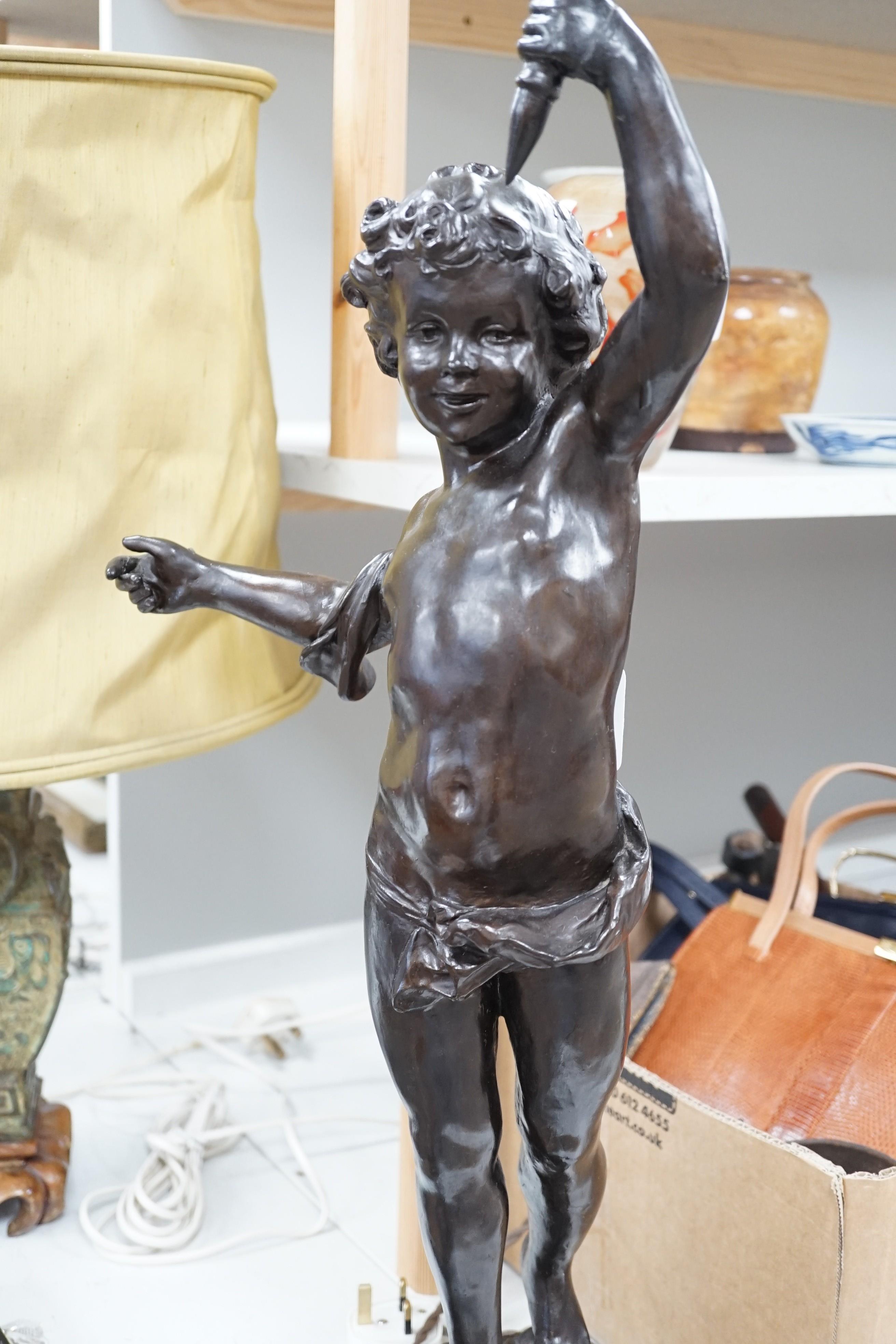A bronzed composition cherub table lamp with frosted glass shade Height 88 cm.